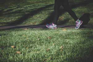 a person's legs and shoes on a track