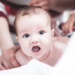 a baby being examined by a doctor