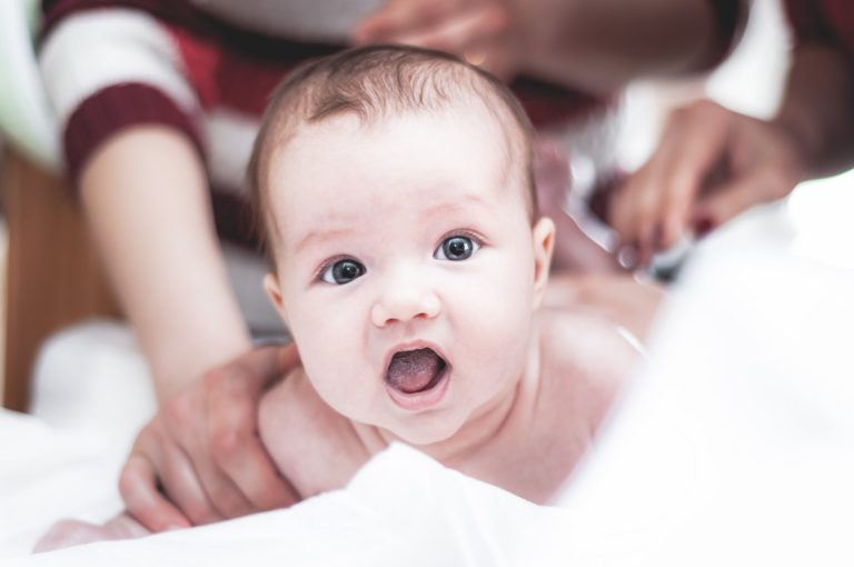 a baby being examined by a doctor