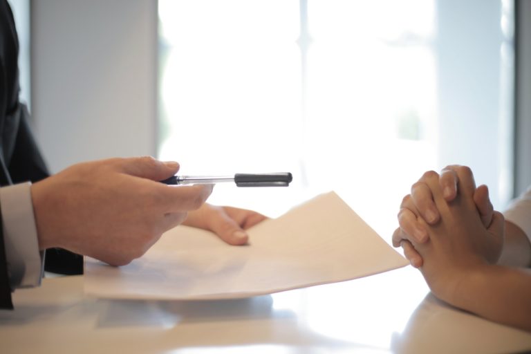 a person writing on a paper