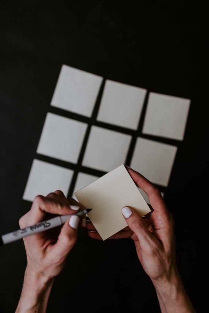 a person drawing on a white board