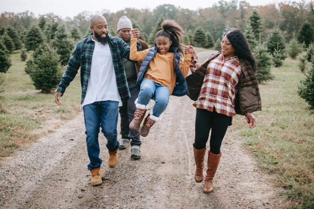 a group of people walking on a dirt path