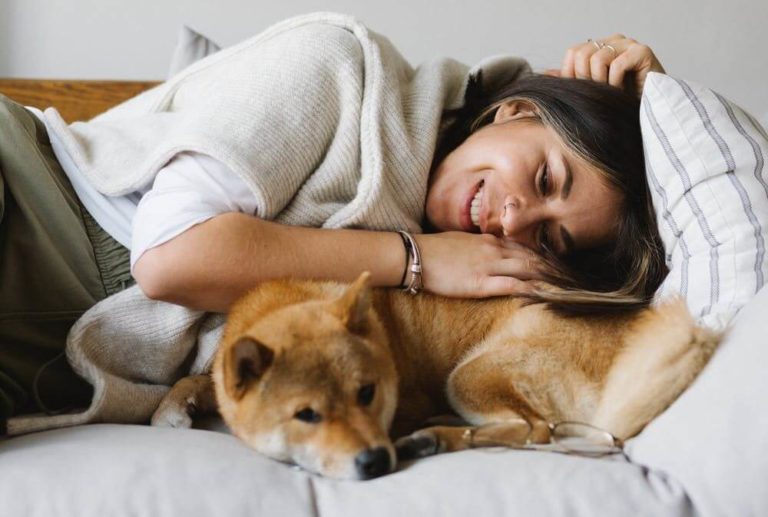 a man lying on a bed with a dog