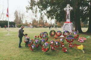 A father and son taking a moment at a memorial.